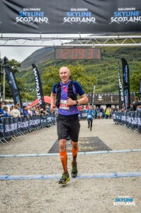 Crossing the finish line of the Three Mealls Trail race at Skyline Scotland