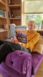 John Kraijenbrink reading Above the Clouds for a review